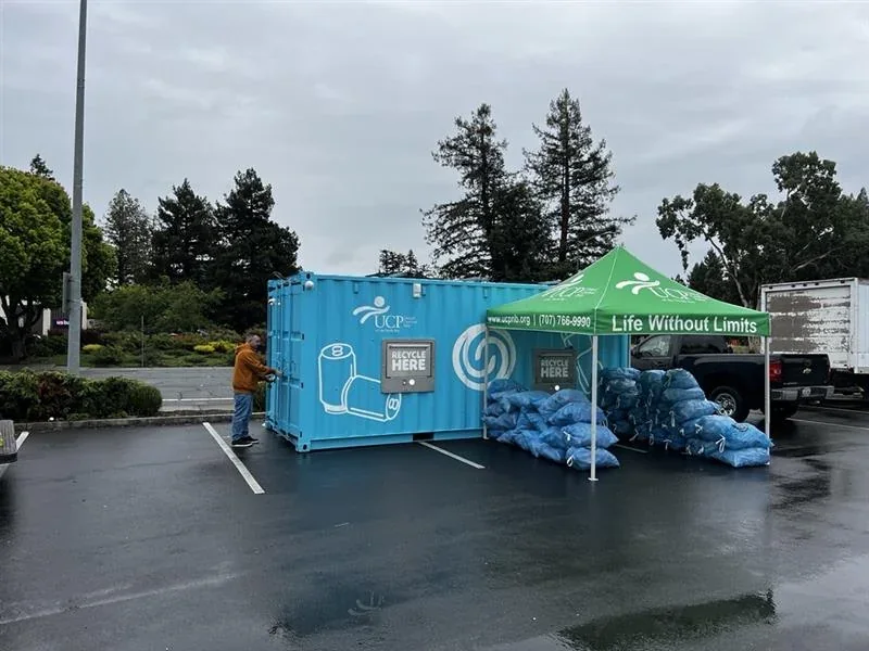 Blue Recycletek EcoPod bag-drop enclosure with recyclable bags beside it